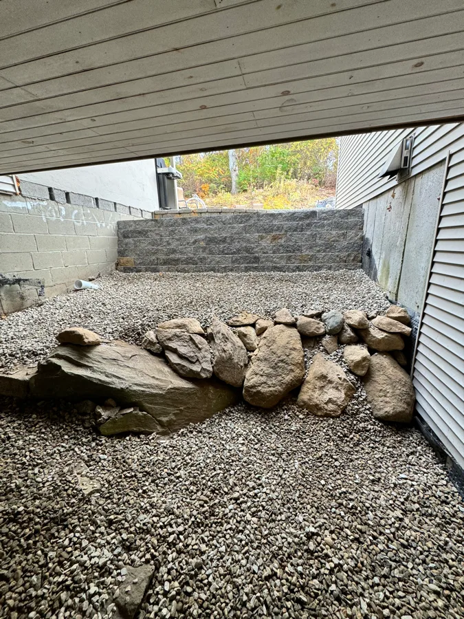Rock garden drainage and retaining wall installation by Evergreen Landscaping
