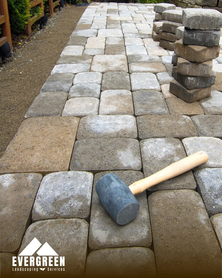Cobblestone paver walkway under installation by Evergreen Landscaping